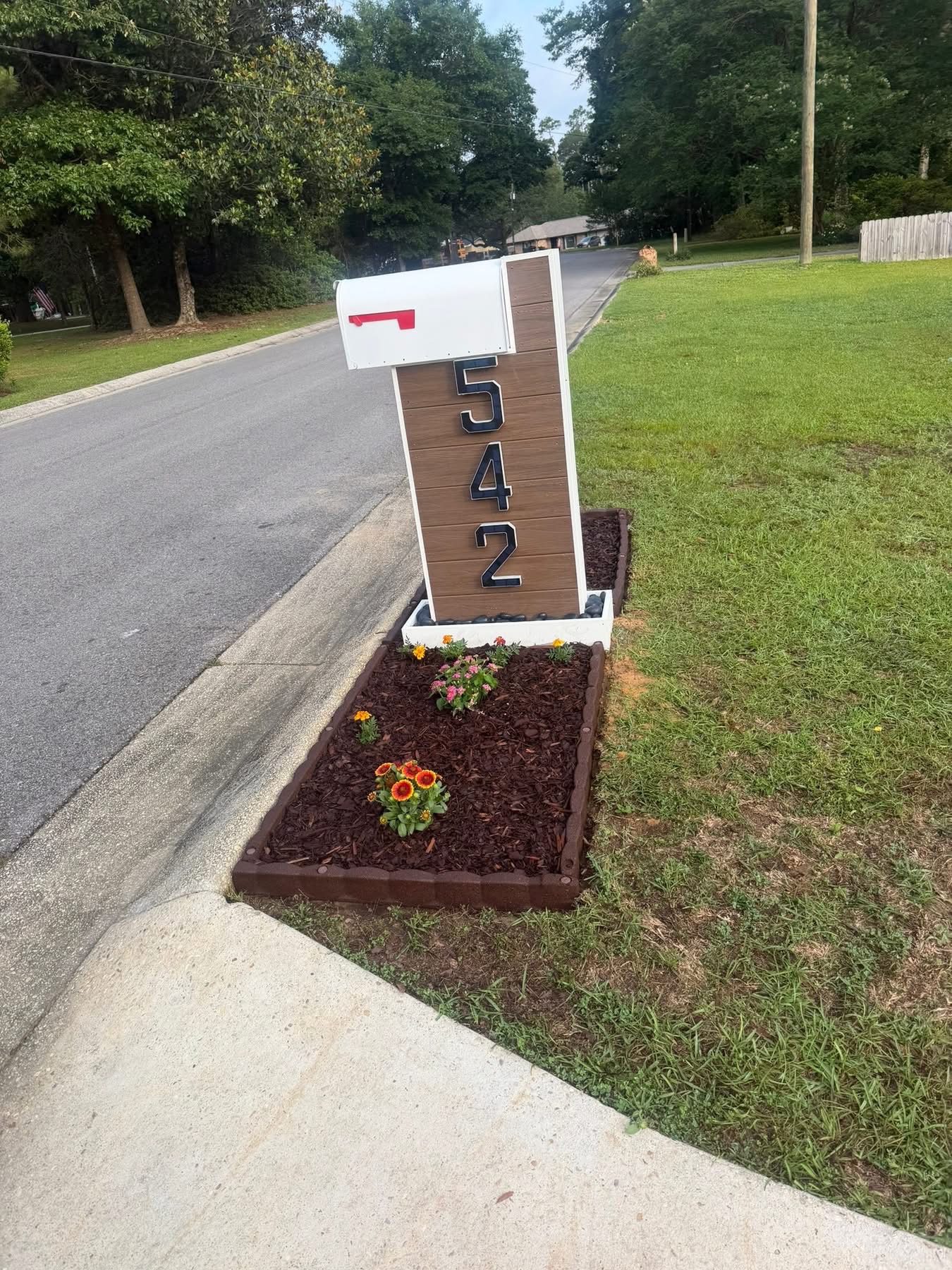 Custom mailbox with mulched flower bed and house numbers