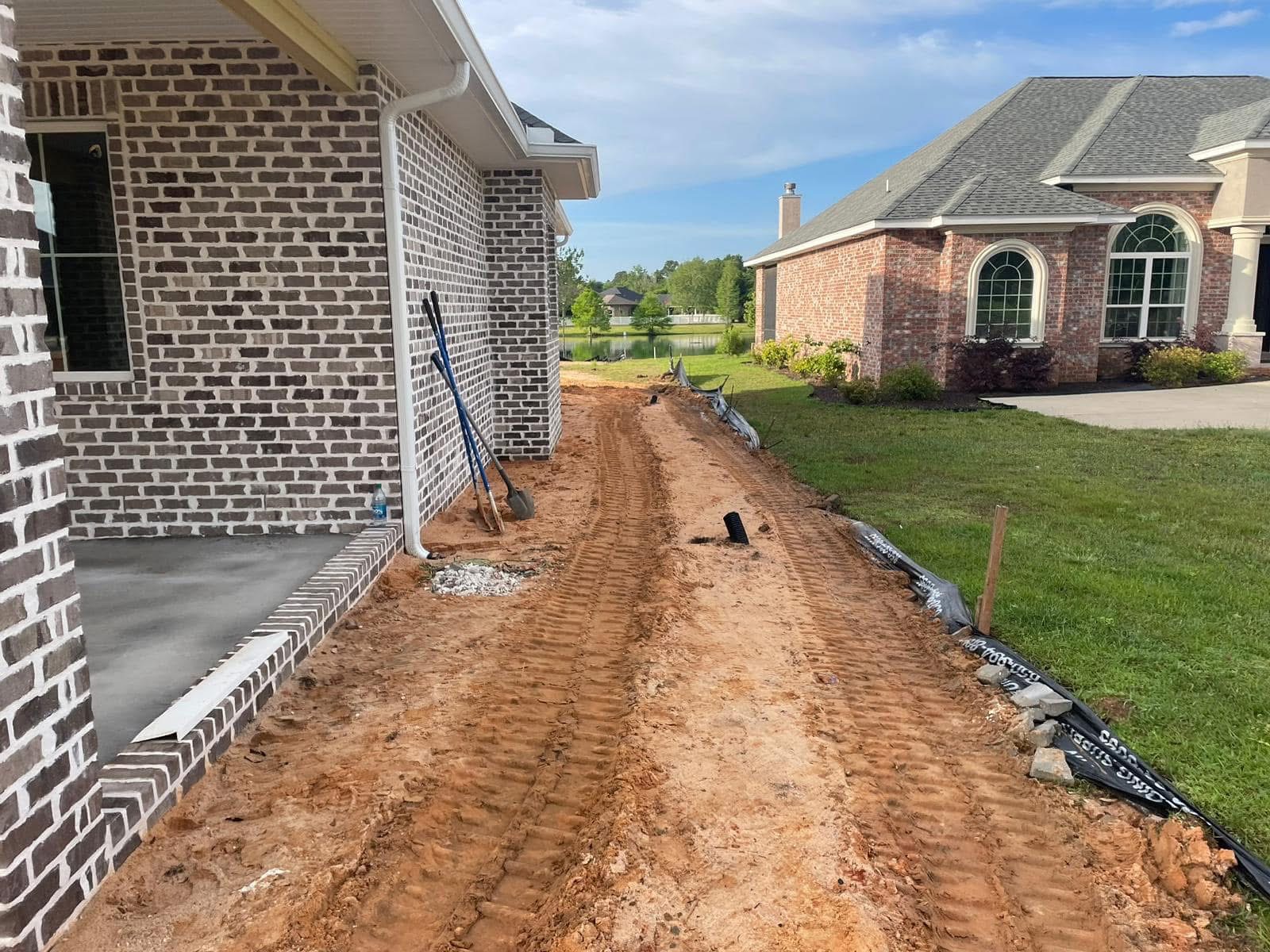 Graded driveway path along the side of a brick home